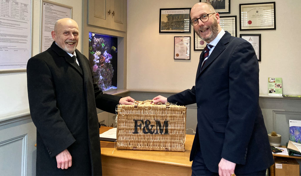 Graeme Turnbull being congratulated on 40 years from James Ray.